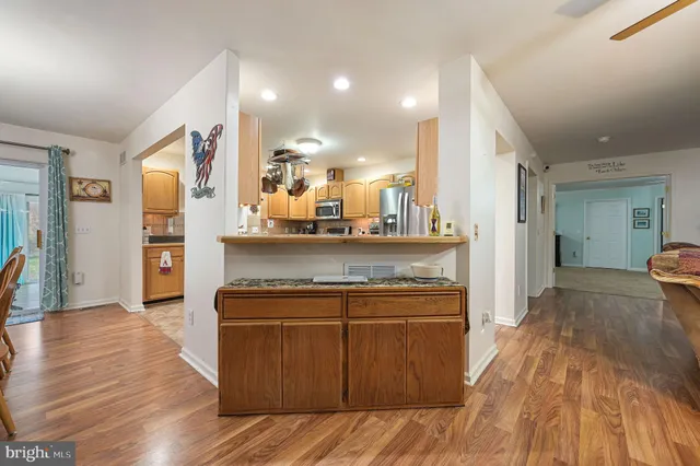 a view of a kitchen cabinets and wooden floor