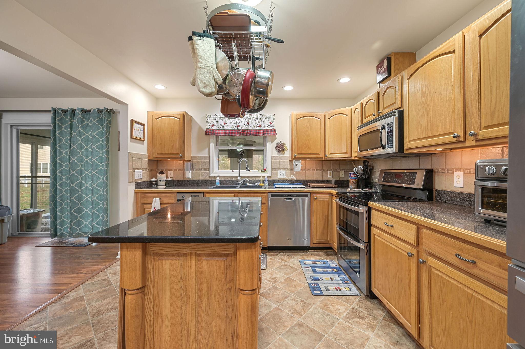 850 Arthursville Road Hartly, DE 19953 - Photo 14 of 35 a kitchen with stainless steel appliances granite countertop a sink a stove and cabinets