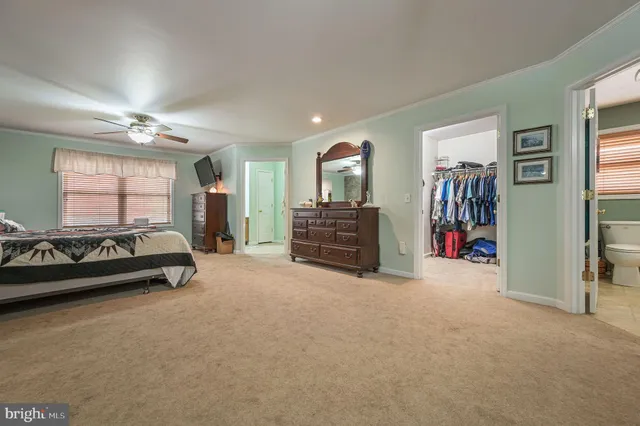 a view of a livingroom with furniture and a large window