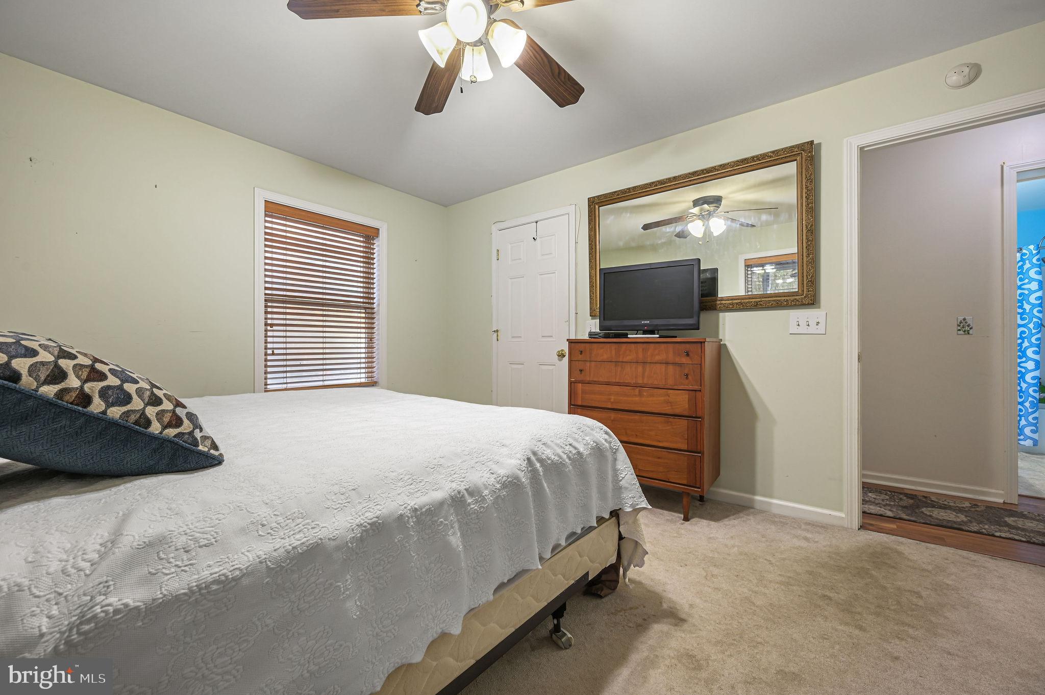 850 Arthursville Road Hartly, DE 19953 - Photo 21 of 35 a bedroom with a bed and a flat tv screen on dresser