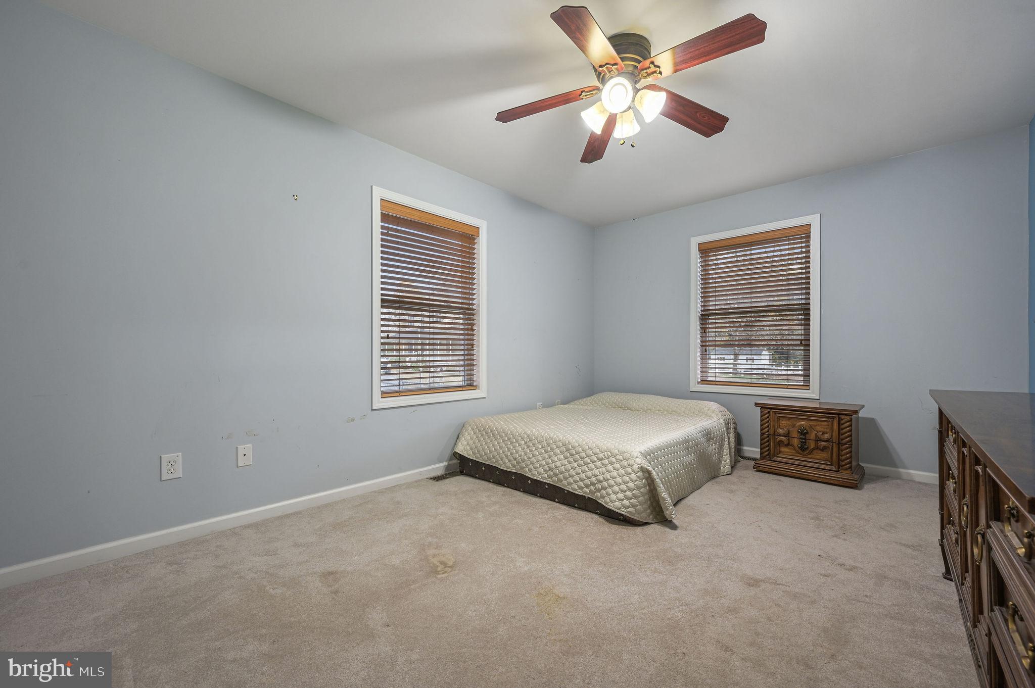 850 Arthursville Road Hartly, DE 19953 - Photo 22 of 35 a spacious bedroom with a bed and a chandelier