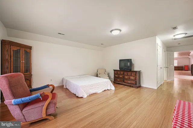 a bedroom with furniture and a flat screen tv