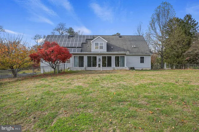 a view of a house with a garden and trees