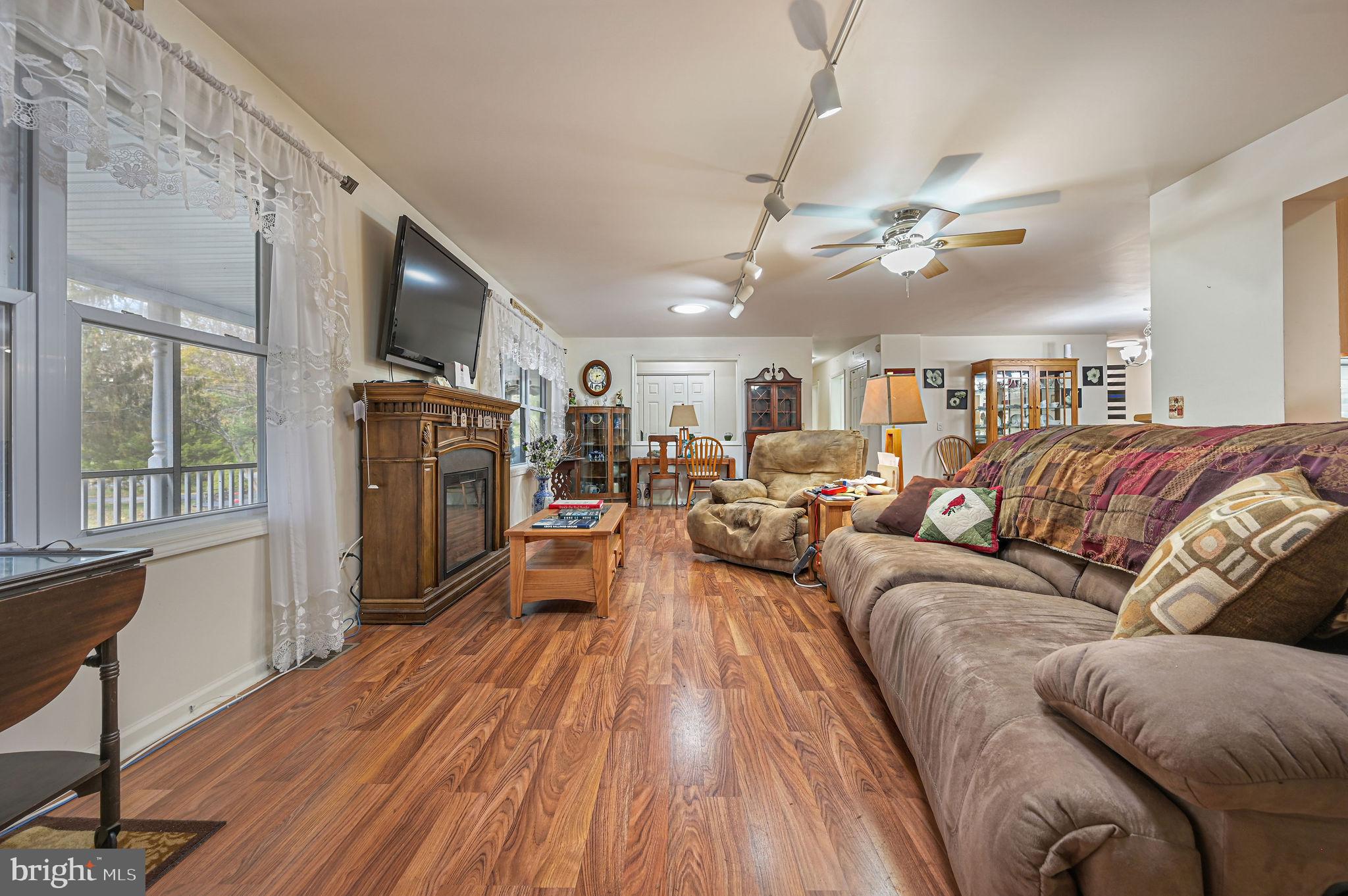 850 Arthursville Road Hartly, DE 19953 - Photo 10 of 35 a living room with furniture a ceiling fan and a flat screen tv