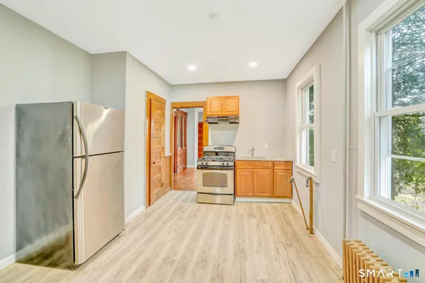 a kitchen with stainless steel appliances a refrigerator and a stove top oven