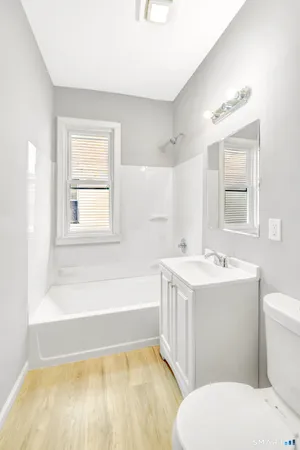 a bathroom with a sink a toilet and bathtub