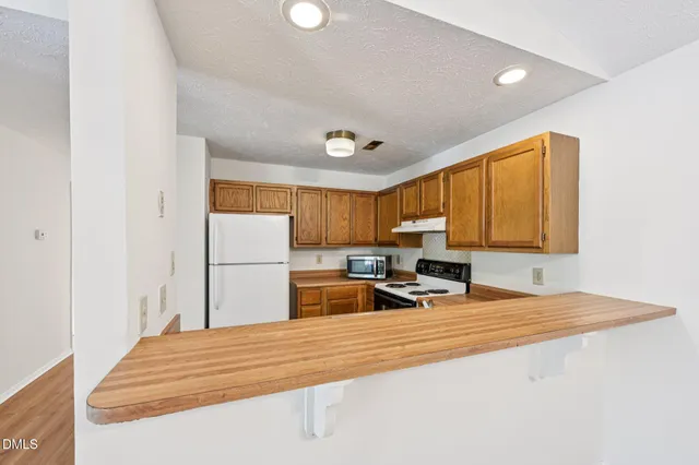 a kitchen with a sink appliances and cabinets