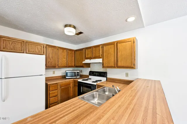 a kitchen with a sink a stove and refrigerator