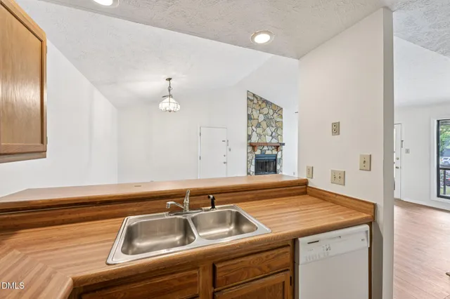 a kitchen that has a sink stainless steel appliances and cabinets