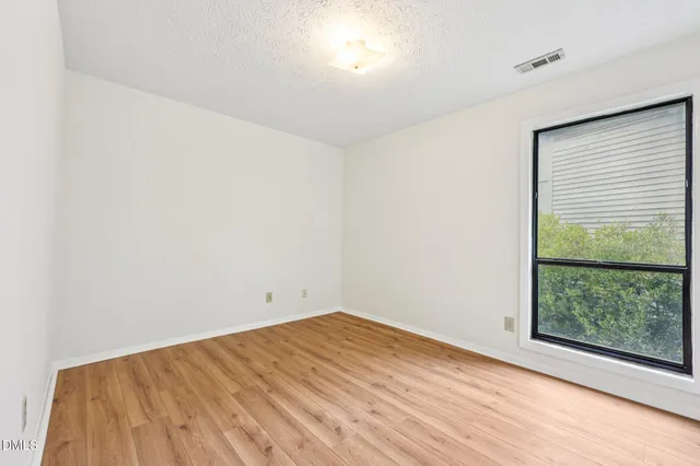 a view of an empty room and wooden floor