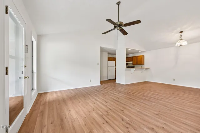 a view of empty room with wooden floor