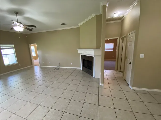 a view of livingroom with an empty space and a fireplace