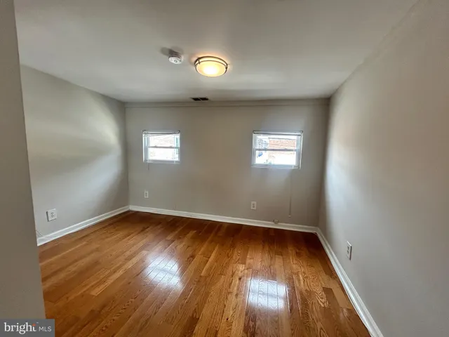an empty room with wooden floor