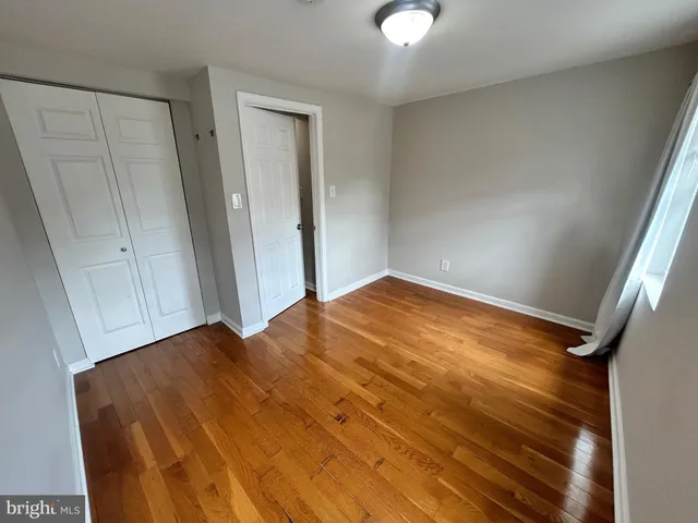wooden floor in an empty room with a staircase