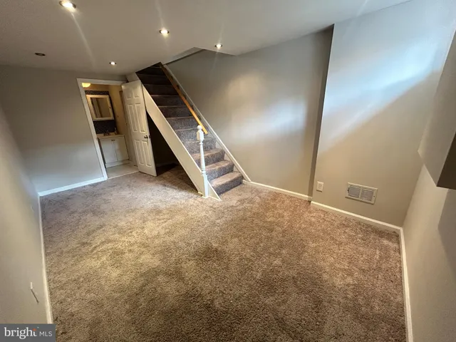 a view of an empty room with stairs