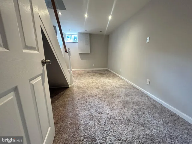 an entryway in an empty room with stairs
