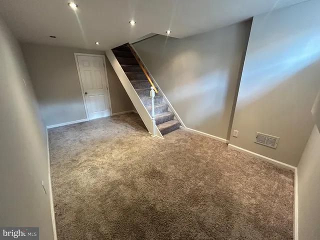 a white toilet sitting next to a bathroom sink
