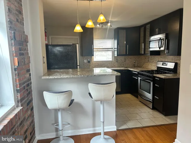 a kitchen with stainless steel appliances a sink and a microwave
