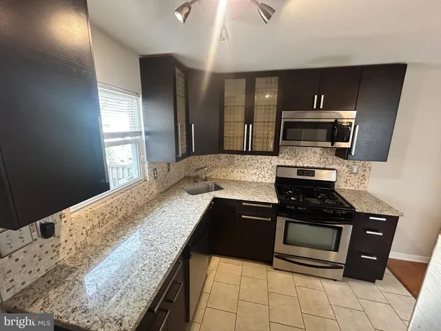 a kitchen with a stove and a refrigerator
