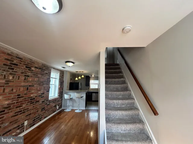 a view of entryway and hall with wooden floor