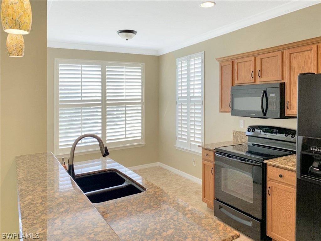 4100 Cherrybrook Loop Fort Myers, FL 33966 - Photo 7 of 25 a kitchen with granite countertop a stove and a sink