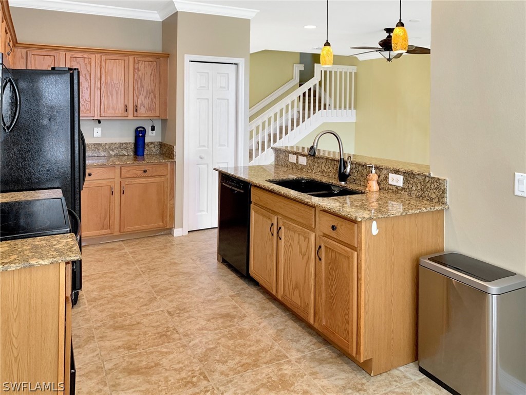 4100 Cherrybrook Loop Fort Myers, FL 33966 - Photo 9 of 25 a kitchen with stainless steel appliances granite countertop a sink stove and refrigerator