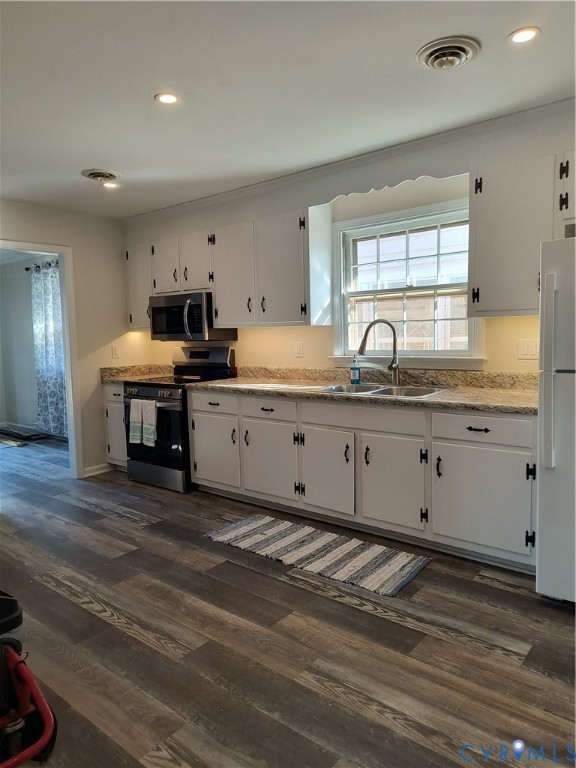 9913 Graves Road Petersburg, VA 23803 - Photo 14 of 24 a kitchen with granite countertop a sink cabinets and wooden floor