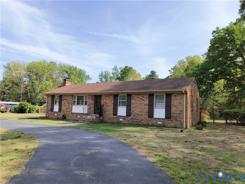 9913 Graves Road Petersburg, VA 23803 - Photo 2 of 24 a front view of a house with a yard and trees