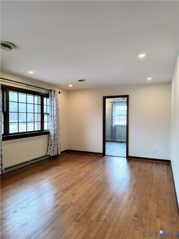 9913 Graves Road Petersburg, VA 23803 - Photo 6 of 24 an empty room with wooden floor and windows