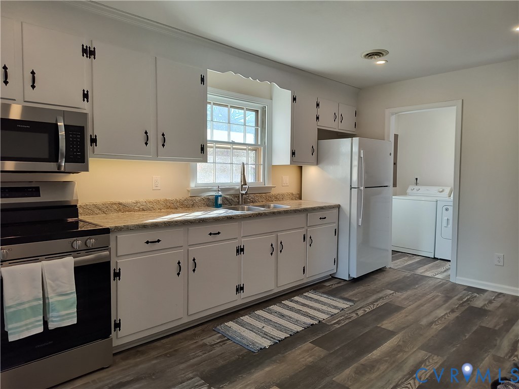 9913 Graves Road Petersburg, VA 23803 - Photo 7 of 24 a kitchen with stainless steel appliances granite countertop a refrigerator sink and white cabinets