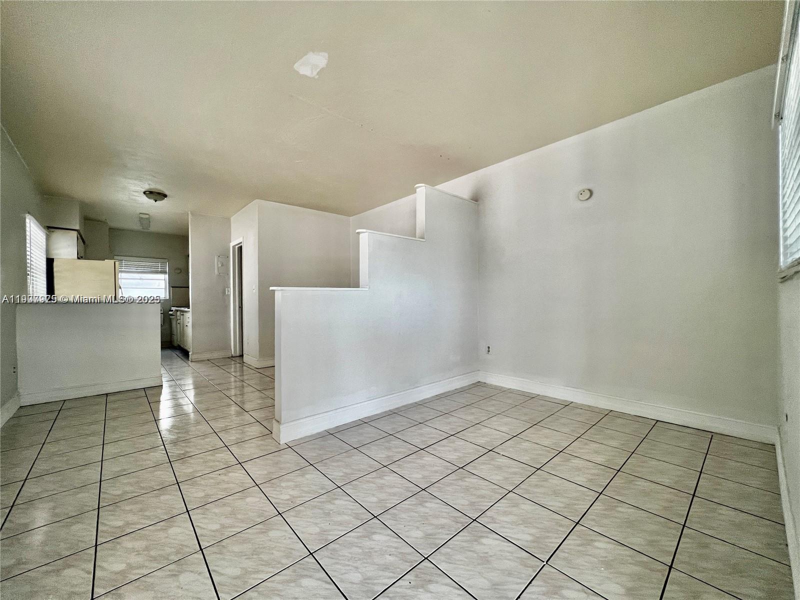 a view of a kitchen with white cabinets
