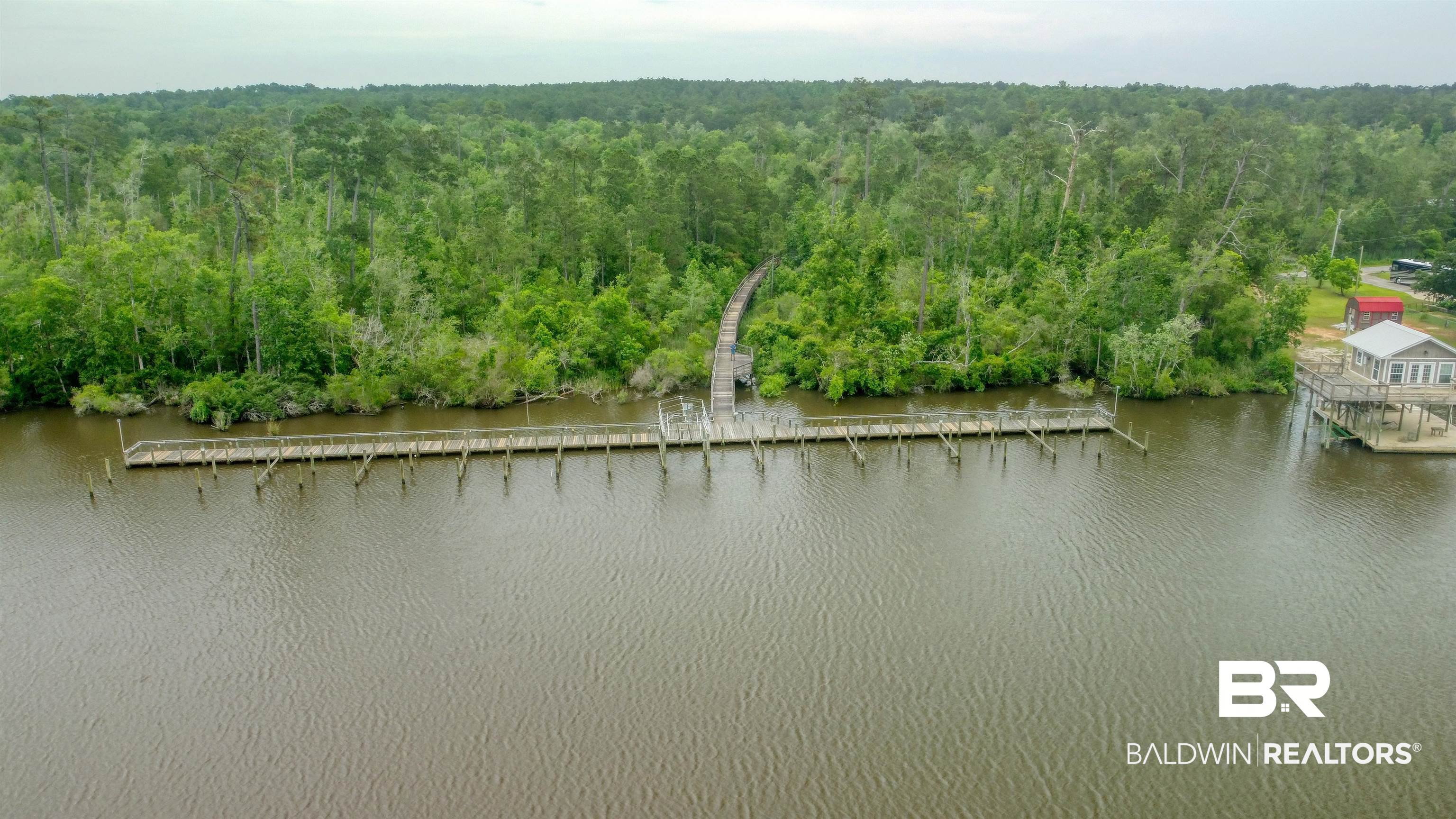 Pandion Drive Foley, AL 36535 - Photo 3 of 9 Drone / aerial view of a forest and a nearby body of water