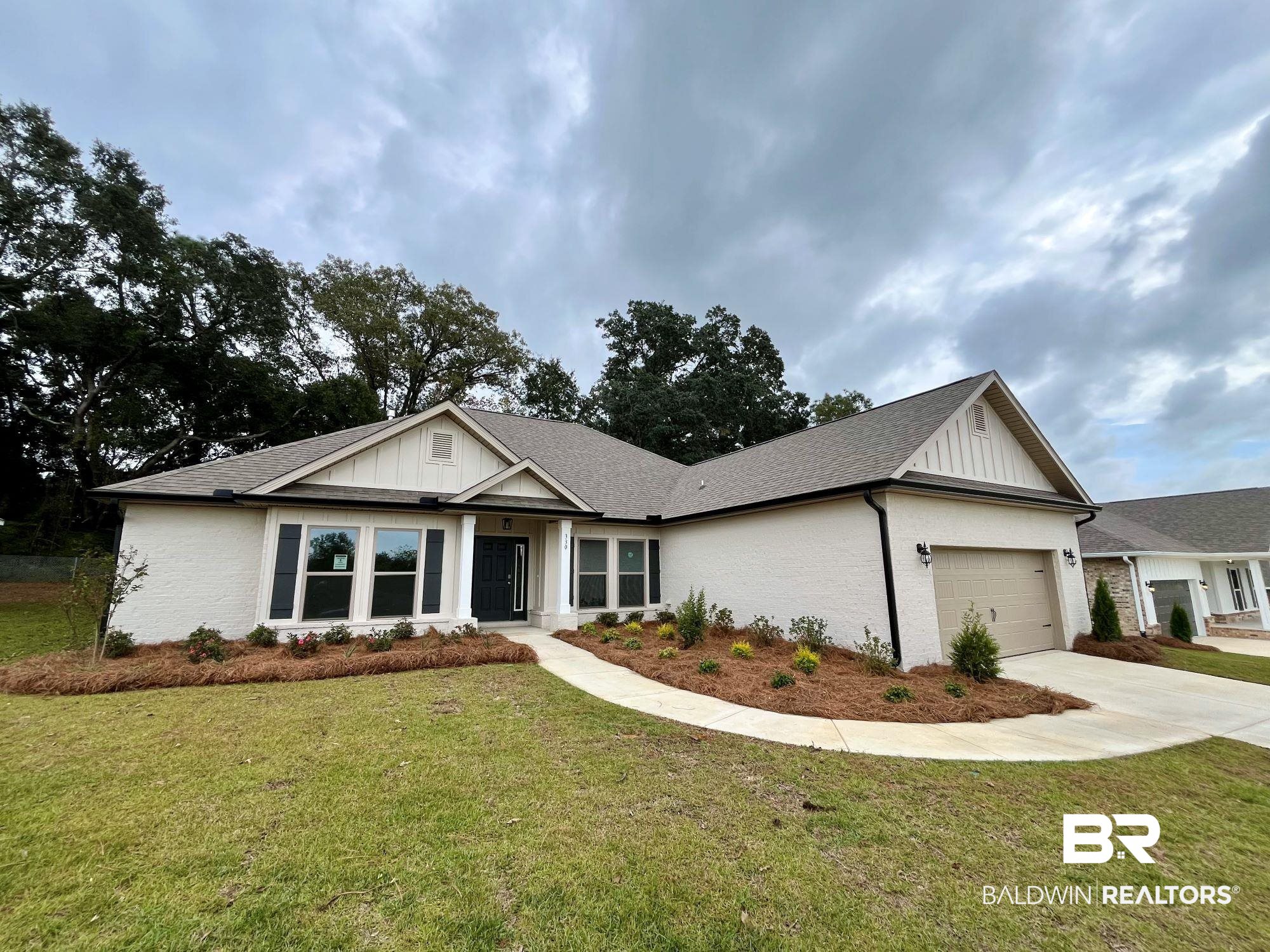 330 Barndling Street Fairhope, AL 36532 - Photo 2 of 31 View of front facade featuring a garage and a front lawn