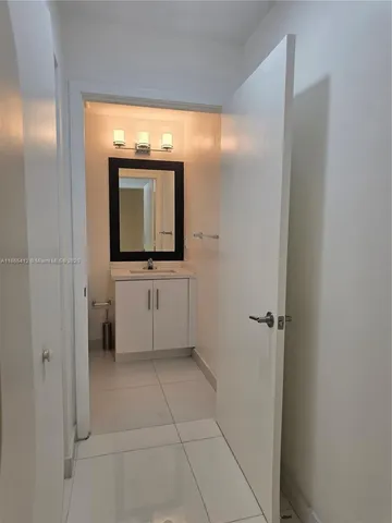 a bathroom with a sink a mirror and a shower