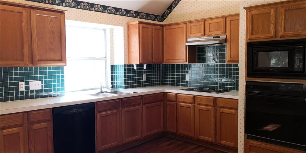 12006 Hispania Court Austin, TX 78727 - Photo 2 of 13 a kitchen with stainless steel appliances a sink and cabinets