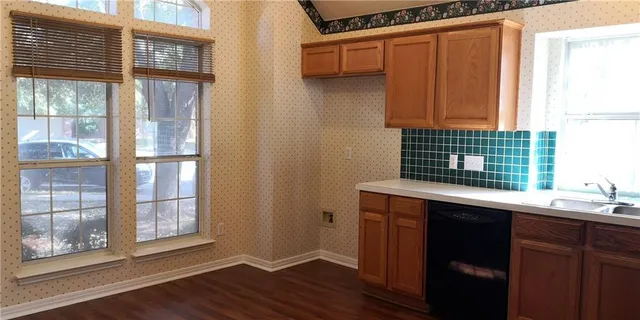 a kitchen with a sink and a window