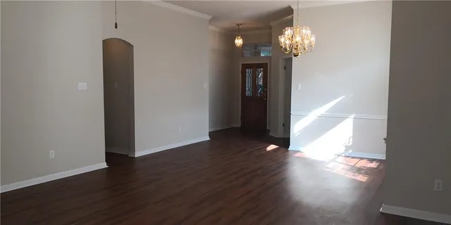a view of a room with wooden floor and staircase