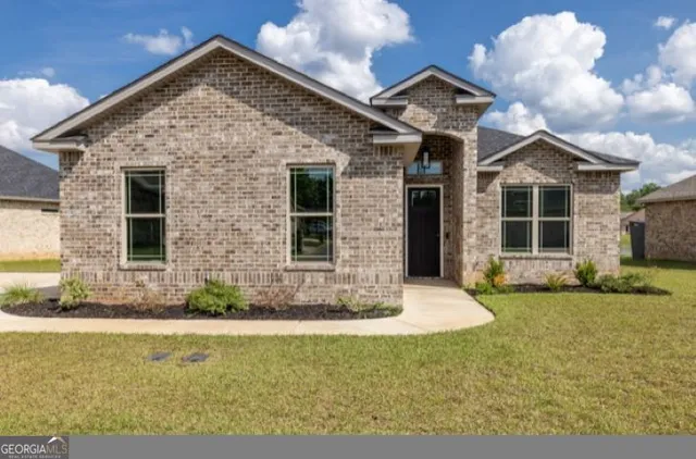 a front view of a house with a yard