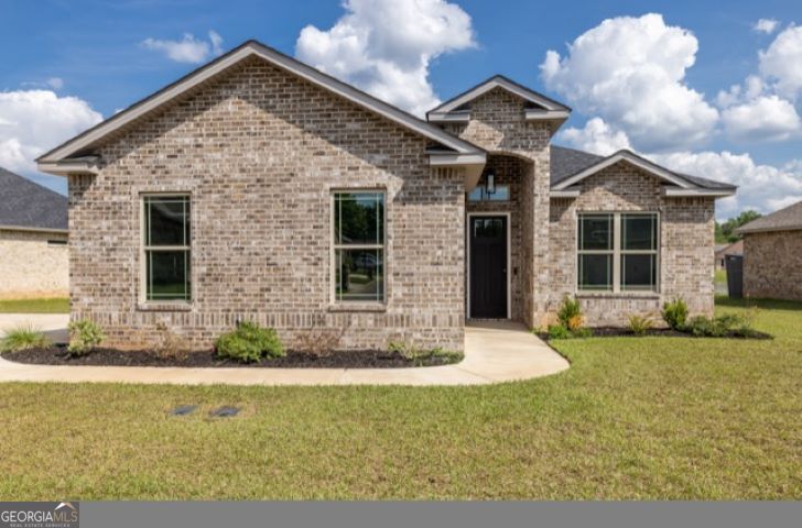 a front view of a house with a yard