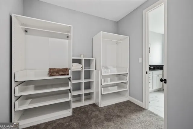 a view of walk in closet with empty racks