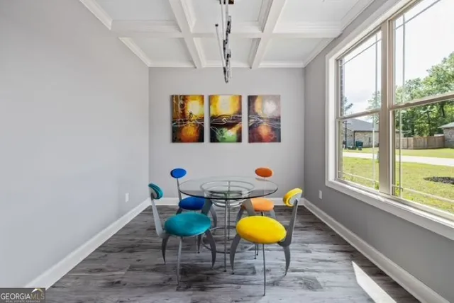 a view of a room with a table and chairs