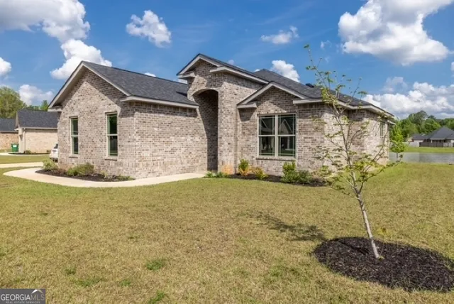a front view of a house with garden