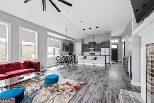 a living room with furniture and a wooden floor