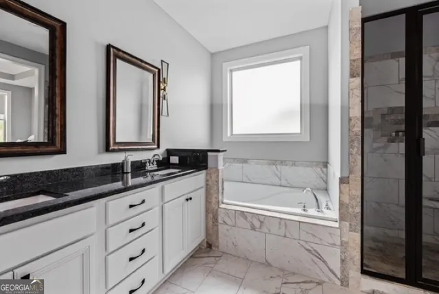 a bathroom with a bathtub sink and mirror