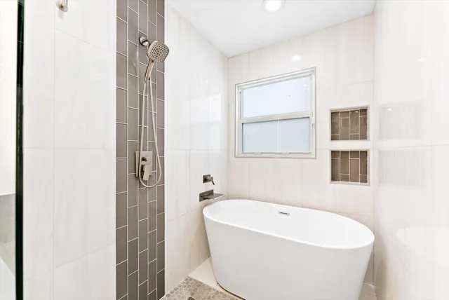 a white bath tub sitting next to a white sink
