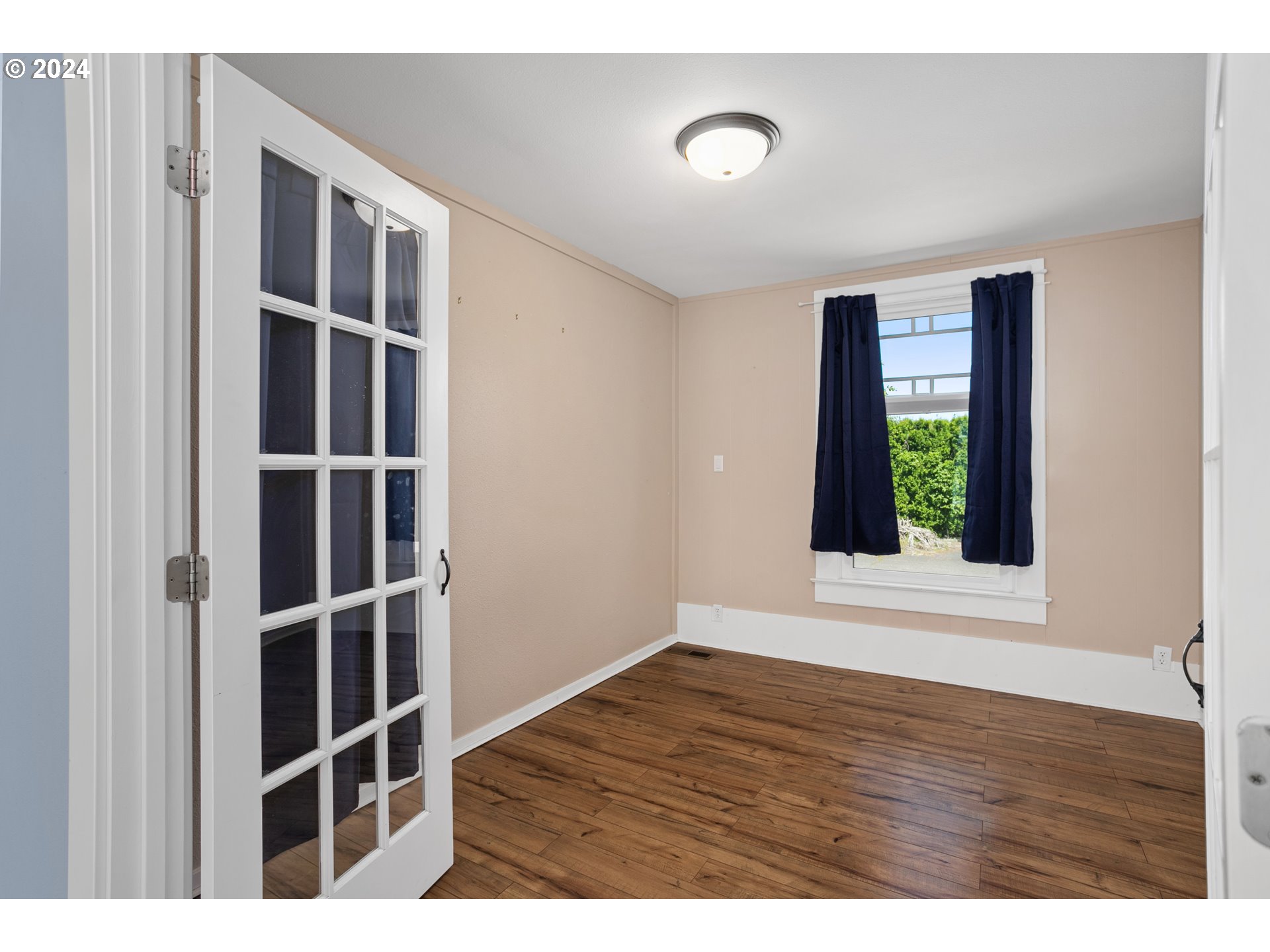 15525 Northeast Caples Road Brush Prairie, WA 98606 - Photo 11 of 40 a view of an empty room with wooden floor and a window