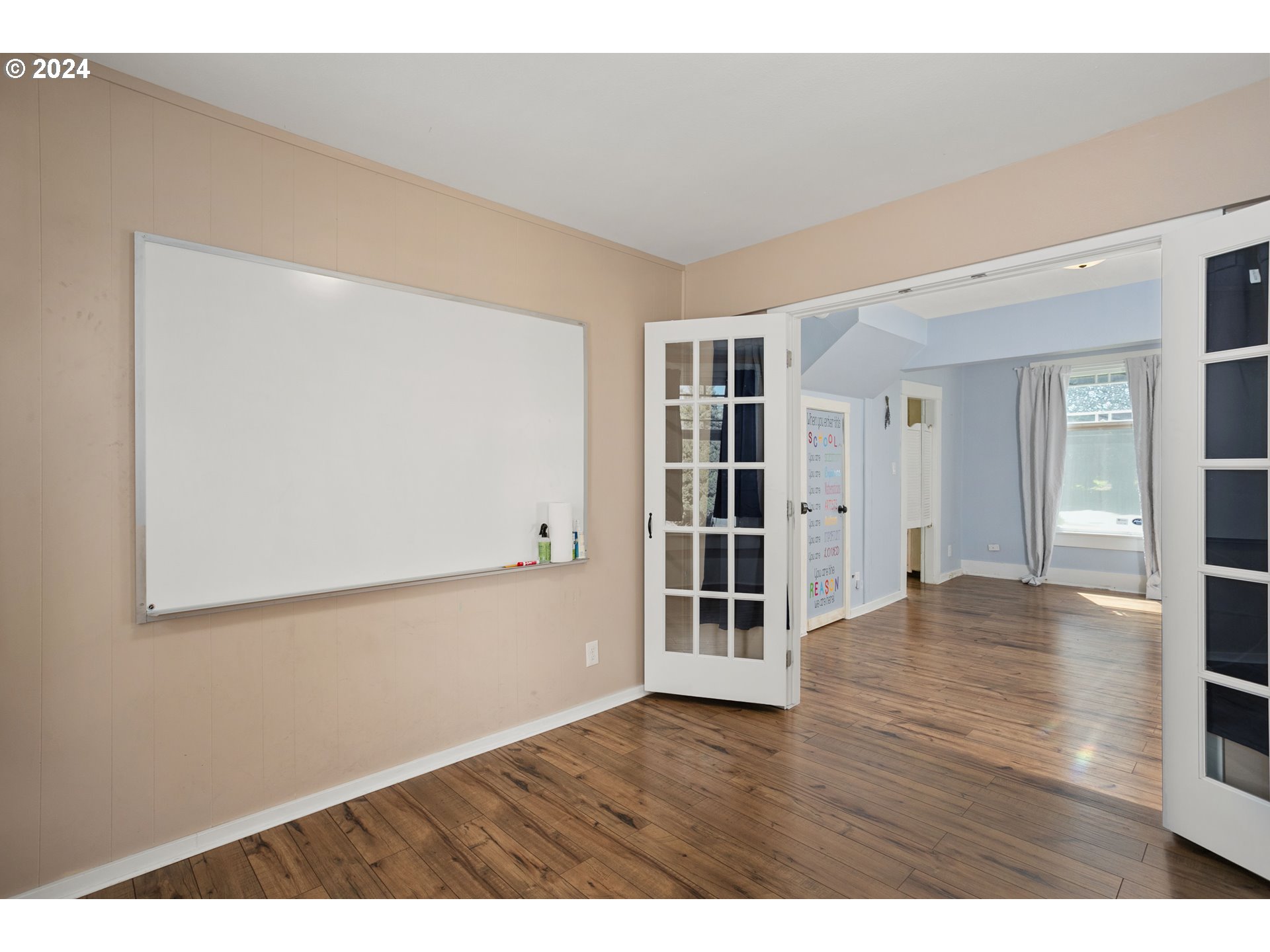 15525 Northeast Caples Road Brush Prairie, WA 98606 - Photo 12 of 40 an empty room with wooden floor and windows