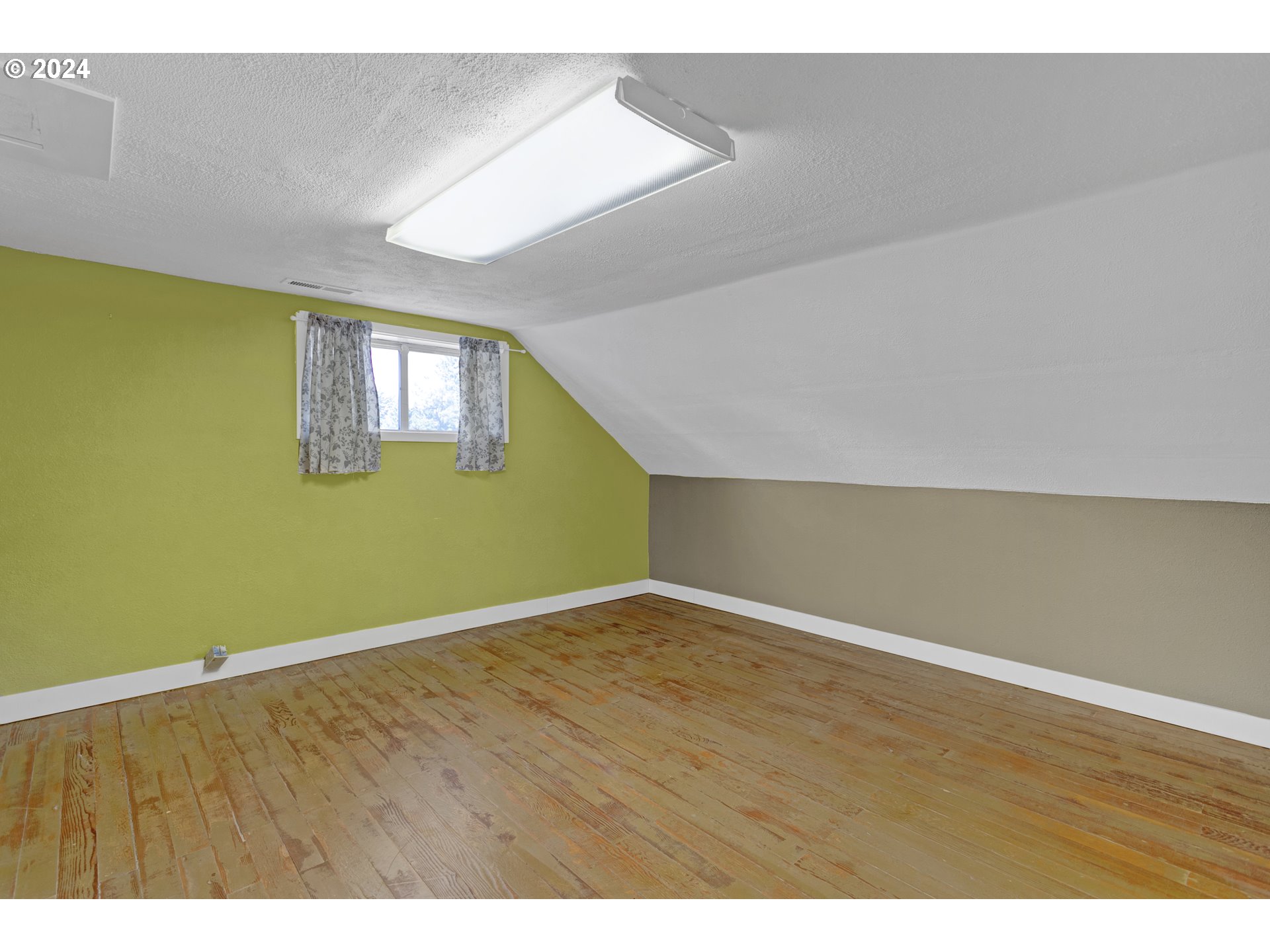 15525 Northeast Caples Road Brush Prairie, WA 98606 - Photo 27 of 40 a view of an empty room with wooden floor and a window