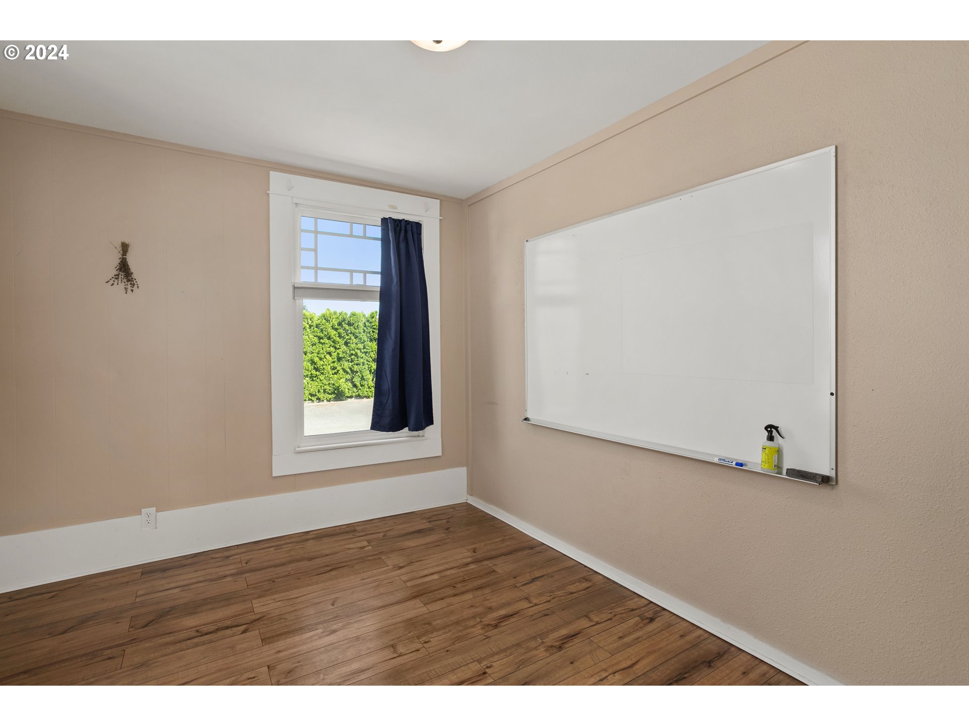 15525 Northeast Caples Road Brush Prairie, WA 98606 - Photo 9 of 40 a view of an empty room with wooden floor and a window