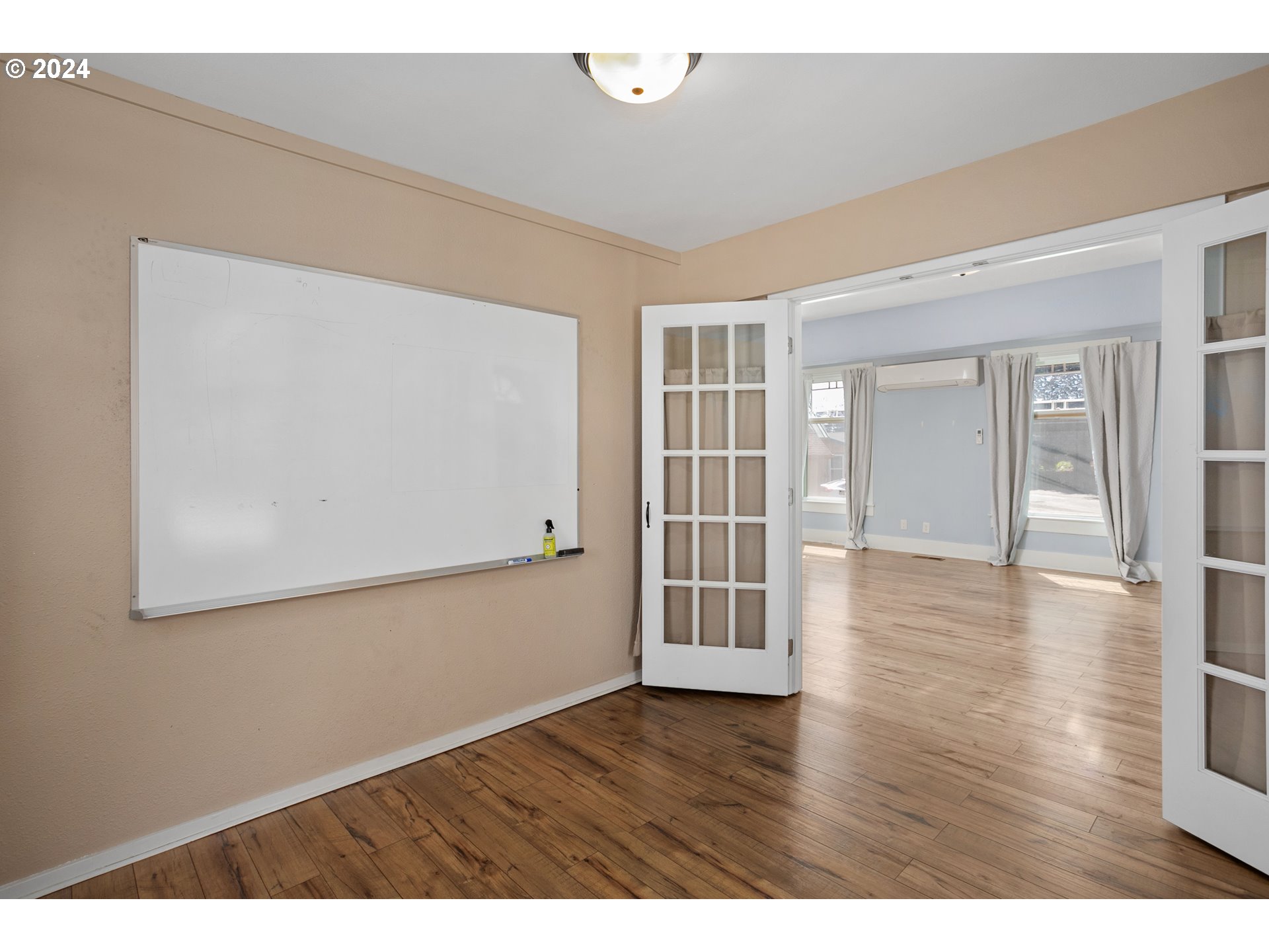 15525 Northeast Caples Road Brush Prairie, WA 98606 - Photo 10 of 40 an empty room with wooden floor and windows